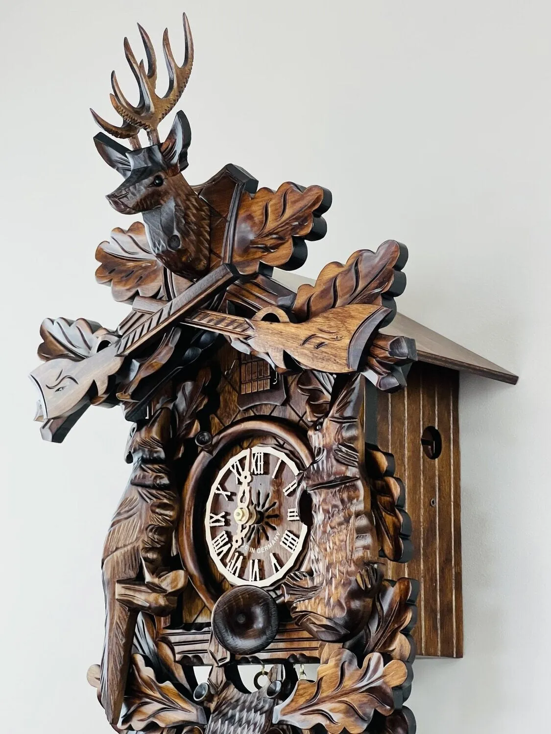 Eight Day Hunter's Cuckoo Clock with Hand-carved Oak Leaves, Animals, Rifles, and Buck